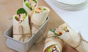 Packed up West Coast Tuna Wraps with brown paper and string