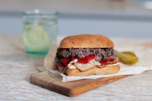 a Tuna Tapenade Sandwich with a side of pickles