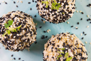 A top view of 3 sesame crusted Smoked Oyster Rice Balls