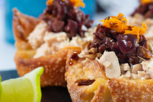 Close up of 2 Crispy Wonton Cups With Orange Tuna And Spicy Olive Tapenade