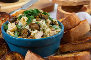 A ramekin of Ocean's Smoked Mussels, Hazelnut And Ricotta Crostini